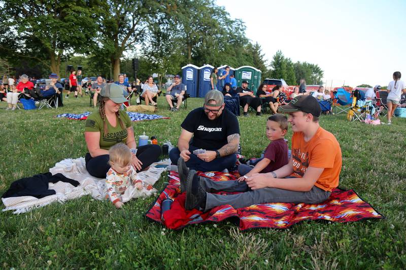 The Meyers Family plays cards before the Elburn Fireworks Show at Lions Park on Saturday, July 6, 2024 in Elburn.