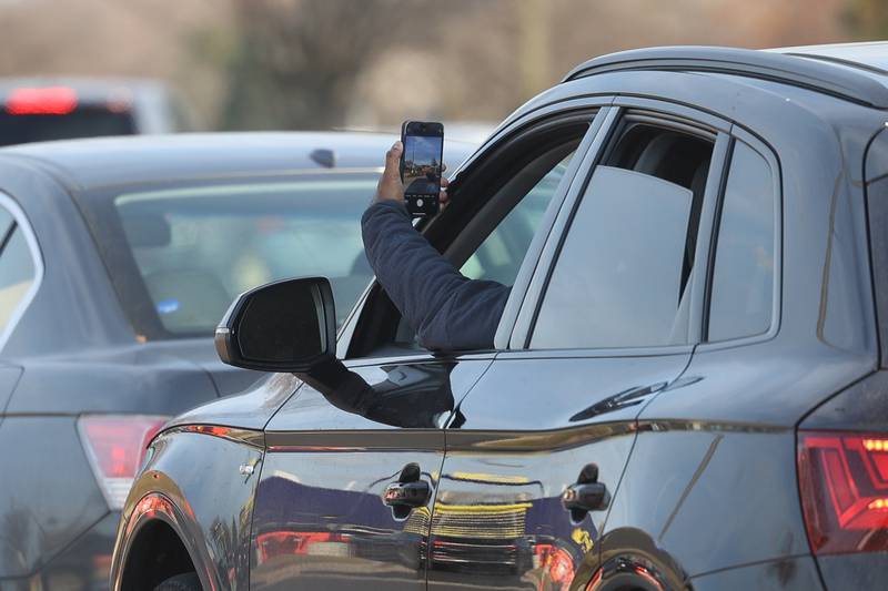 A customer takes a photo as they near CosMc’s, McDonald’s first small format beverage driven concept drive-thru restaurant, on Friday, Dec. 8, 2023, in Bolingbrook.