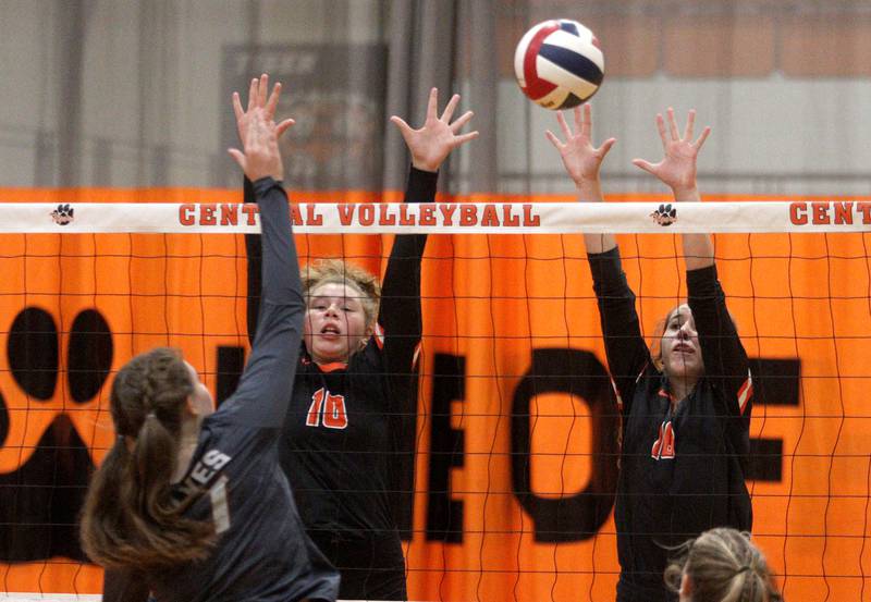 Crystal Lake Central’s Vivian Akalaonu, left, and Anna Starr, right, block against Prairie Ridge in varsity volleyball at Crystal Lake Central Thursday night.
