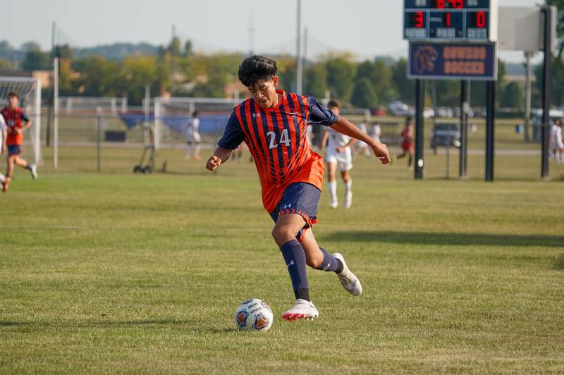 Oswego’s Israel Cortez Jr (24) plays the ball on a fast break for a goal during a soccer match against Batavia at Oswego High School on Thursday, Sep 12, 2024.