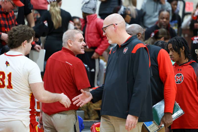 Momence head coach Kevin Ecker, right, congratulates St. Anne head coach Rick Schoon as Schoon reached his 500th career coaching win with a 64-43 victory over Momence in the River Valley Conference semifinals on Tuesday, Feb. 10, 2026.