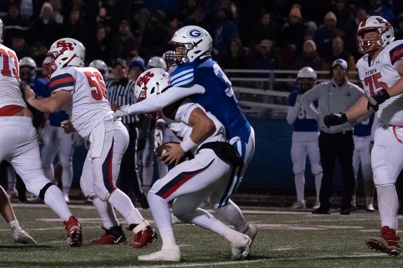 Geneva's Tommy Diamond (37) tackles St. Rita's Tommy Ulatowski (16) in the backfield for loss during a 7A state football playoff game at Geneva High School on Friday, Nov 5, 2021.