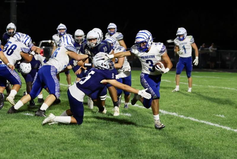 Princeton's Ace Christiansen stiff-arms a Monmouth-Roseville defender Friday at Monmouth. The Tigers lost 31-3.