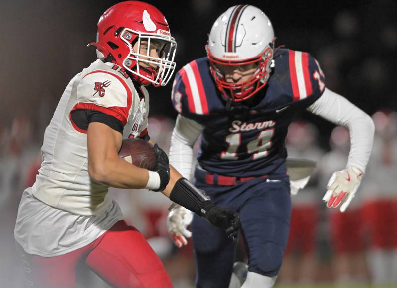 Hinsdale Central's Beau Knapp runs after a catch as South ElginÕs Nick Dodge chases him in an IHSA Class 8A playoff football game in South Elgin on Friday, Oct. 31, 2025.