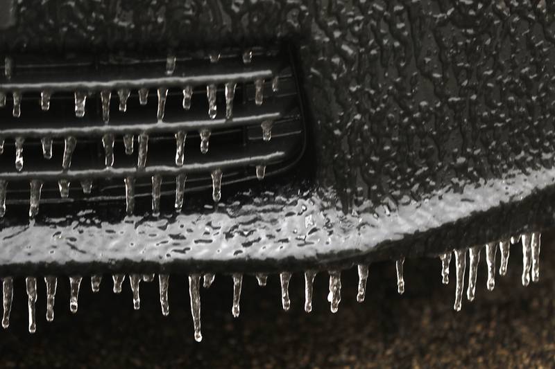 Ice hangs on the grill and bumper of a car parked at the McHenry County Administration Building in Woodstock on Wednesday, Feb. 22, 2023, as a winter storm that produced rain, sleet, freezing rain, and ice moved through McHenry County.