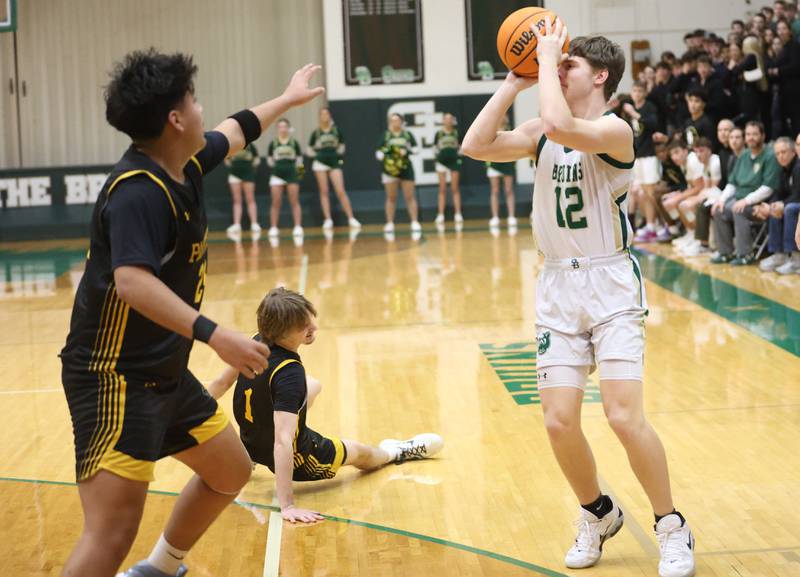 St. Bede's Carson Riva shoots a jump shot over Putnam County's Alan Castro as teammate Jacob Furar falls to the hardwood during the Class 1A Regional quarterfinal game on Monday, Feb. 23, 2026 at St. Bede Academy.