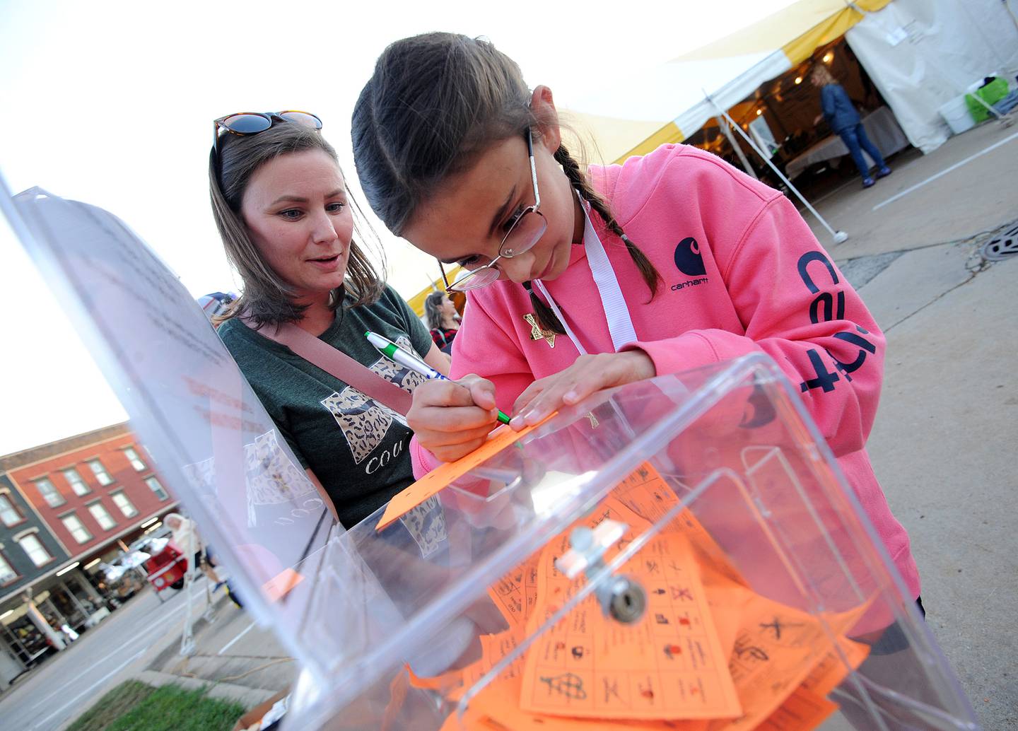 Amanda Wollenweber of Sheridan and her 11-year-old daughter Layla vote for their favorite sandwiches during the Taste of Sandwich, Wednesday, Sept. 25, 2024, in downtown Sandwich.