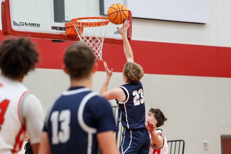 Jordan Heider of Fieldcrest lays ball up in front of rim on Saturday, December 14, 2024 at Hall High School in Spring Valley.