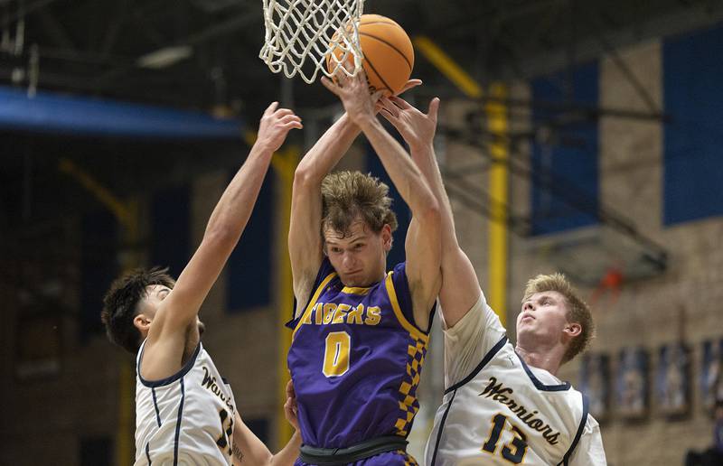 Sherrard’s James Blackwell pulls down a rebound against Sterling’s 11 and 13 Monday, Dec. 16, 2024, at Sterling High School.