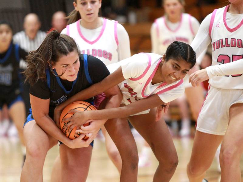 St. Charles North’s Riley Barber (left) and Batavia’s Julia Arulandu battle for possession of the ball during a game on Monday, Dec. 16, 2024 in Batavia.