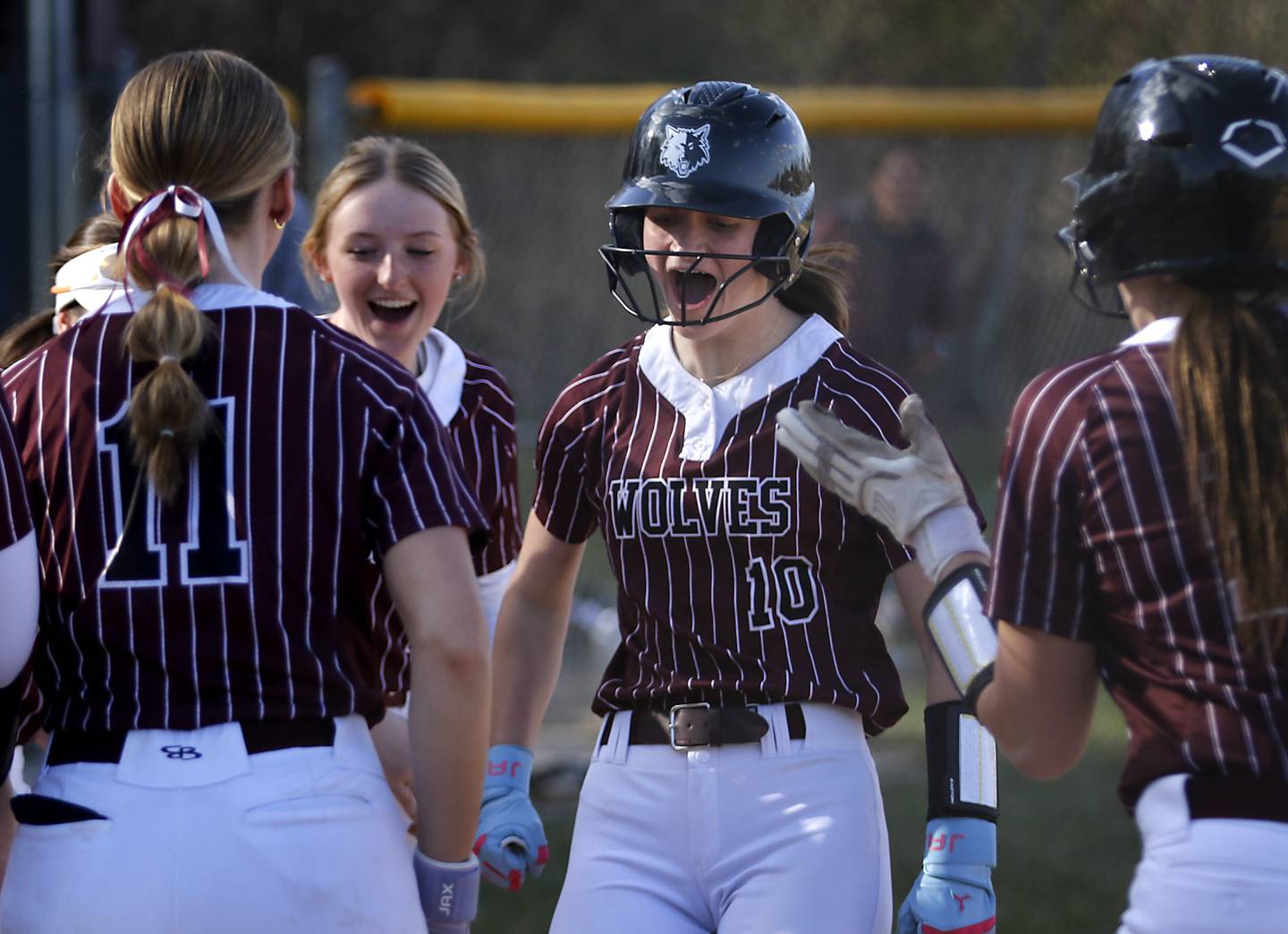 Prairie Ridge's Kylie Carroll celebrates her two-run homer with her teammates during Fox Valley Conference softball game against Huntley on Monday, April 14, 2025, at Prairie Ridge High School in Crystal Lake.