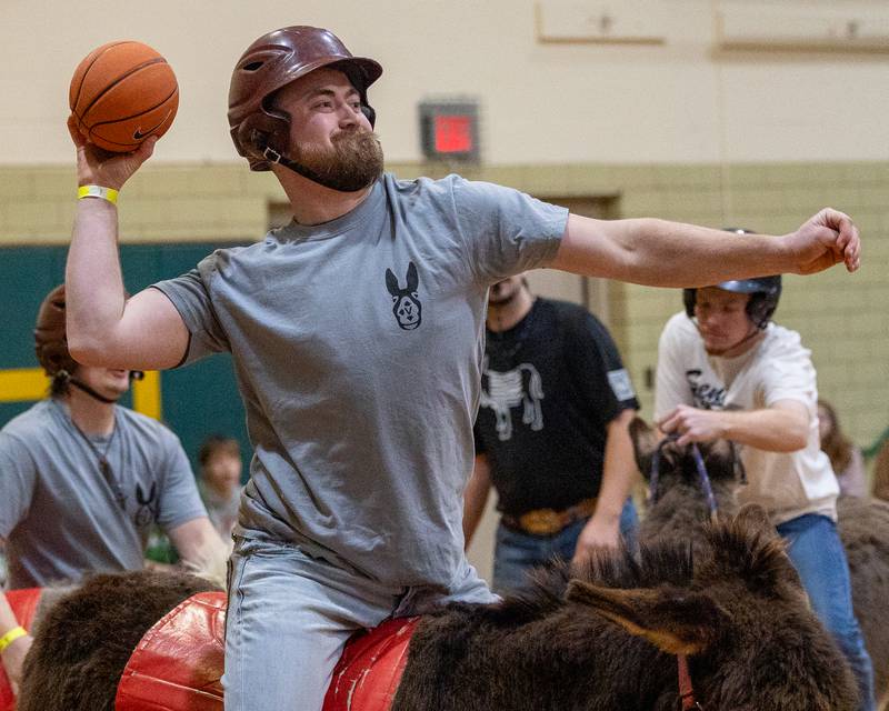 Member of the 'Village Church' team shoots buzzer-beater half court shot in game of Donkey Basketball on Saturday, Feb. 7, 2026 at Seneca High School West Campus in Seneca.