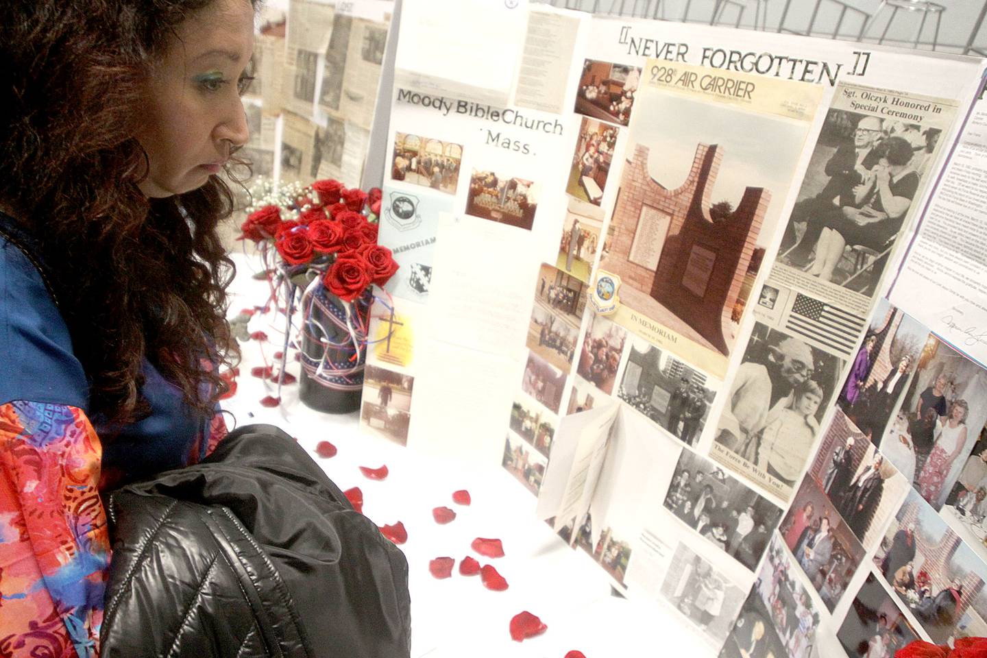Gina Salinas of Chicago views news clippings as a remembrance was held Saturday at Wonder Lake Fire Protection District Station 2 on the 40th anniversary of a midair military jet explosion that happened over the small, rural area northeast of Woodstock. Salinas’ father Augustine James “Jimmy” Salinas and 26 others died as  the plane exploded midair.