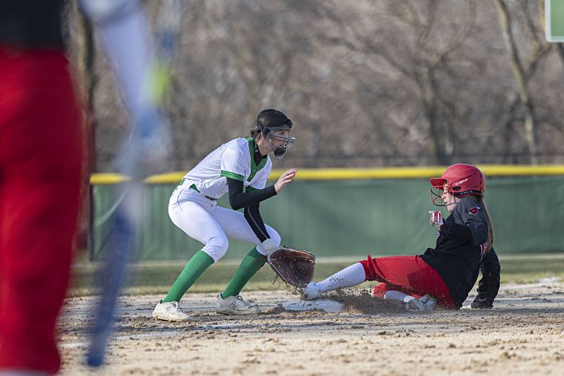 Rock Falls’ Kaltrina Lecaj waits for the ball as Forreston’s McKenna Rummel slides in safe at third Thursday, March 28, 2024 at Rock Falls High School.