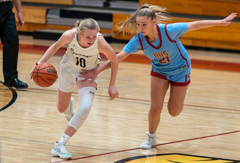 Sycamore's Lexi Carlsen (10) dribbles the ball up the court against Batavia’s Kylee Gehrt (21) during the Batavia MLK Showdown at Batavia High School on Monday, Jan 16, 2023.