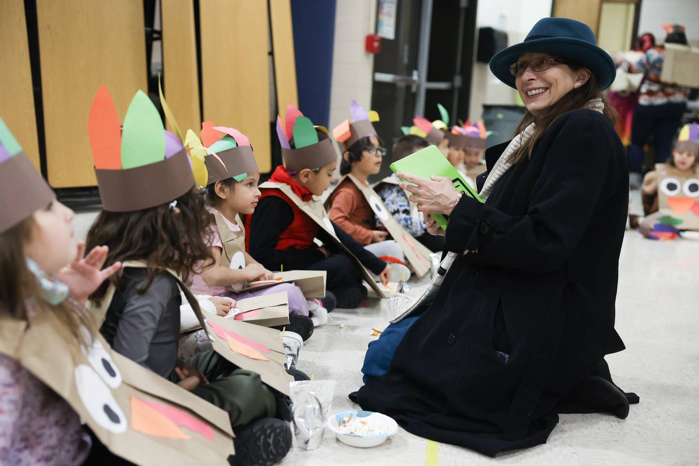 Herald-News Denise Unland talks with students during a Thanksgiving gathering at Thomas Jefferson Elementary School in Joliet on Friday.