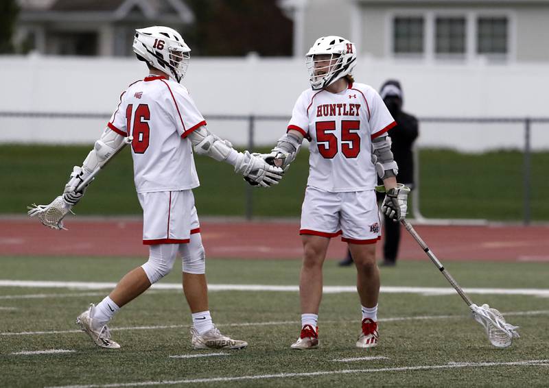 Huntley's Connor Ardell and his teammate, Andrew Baumley, celebrate a goal during a boys lacrosse match Tuesday, May 3, 2022, between Huntley and Palatine at Huntley High School.
