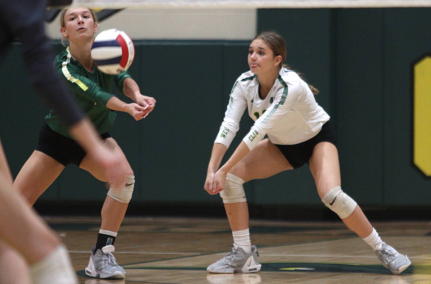 Crystal Lake South’s  Gabby Wire, left, and Bobbi Wire play the ball against Prairie Ridge in varsity volleyball at Crystal Lake South Tuesday night. The Gators won in three sets.
