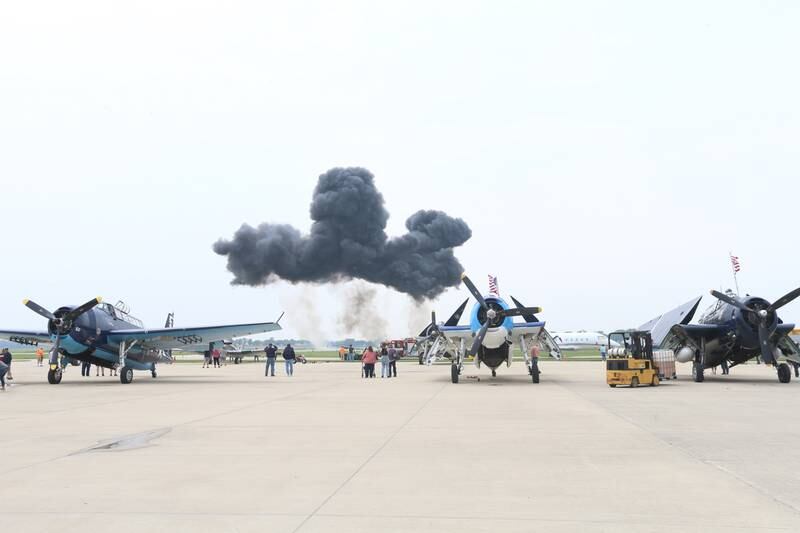 Smoke from a "Wall of Fire" explosion lights the horizon behind a TBM Aircraft during the TBM Avenger Reunion on Friday, May 19, 2023 at the Illinois Valley Regional Airport in Peru.
