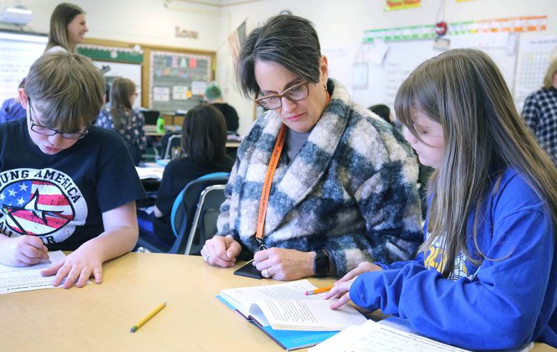 Mary Lynn Buckner, longtime educator at Littlejohn Elementary School, supports Nicole Schmidt's fifth-grade class during their individual work time Tuesday, March 14, 2023, at the school in DeKalb.