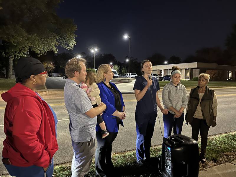 Katherine Soprych, an Intensive Care Unit nurse, holds a microphone while speaking to a crowd outside Ascension Saint Joseph Medical Center in Joliet about the hospital's staffing situation on Saturday, Oct. 22, 2022. Soprych is joined by John Fitzgerald, staff representative for nurses, Julia Bartmes, Illinois Nurses Association executive director, Hannah Puhr, an emergency room nurse and Pat Meade, treasurer for the St. Joseph Nurses Association.