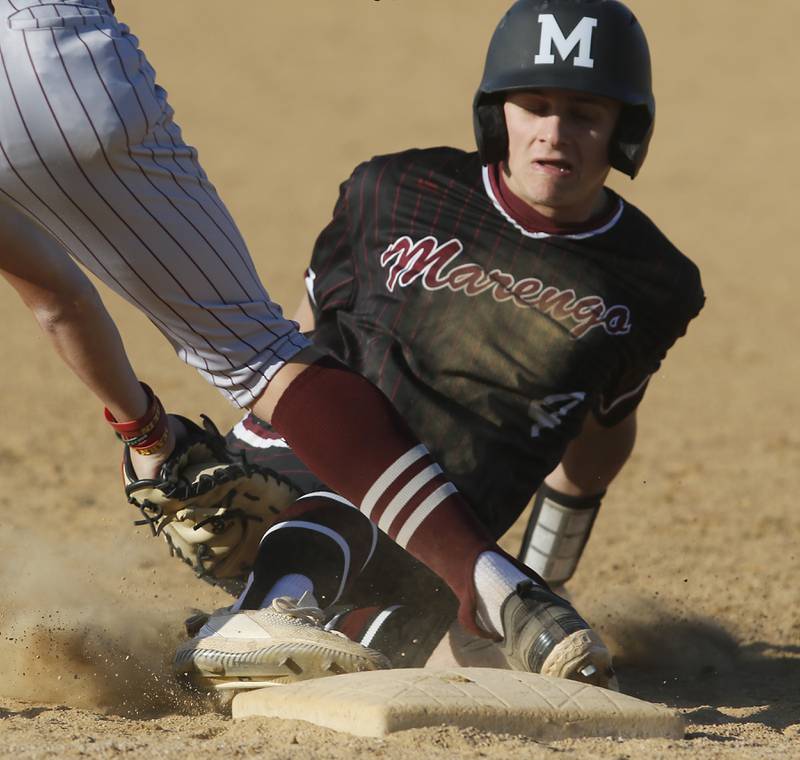 Marengo's Drew Johnson safely slides back into first base before the tag of Richmond-Burton's Ray Hannemann during a Kishwaukee River Conference baseball game on Thursday, April 25, 2024, at Marengo High School.