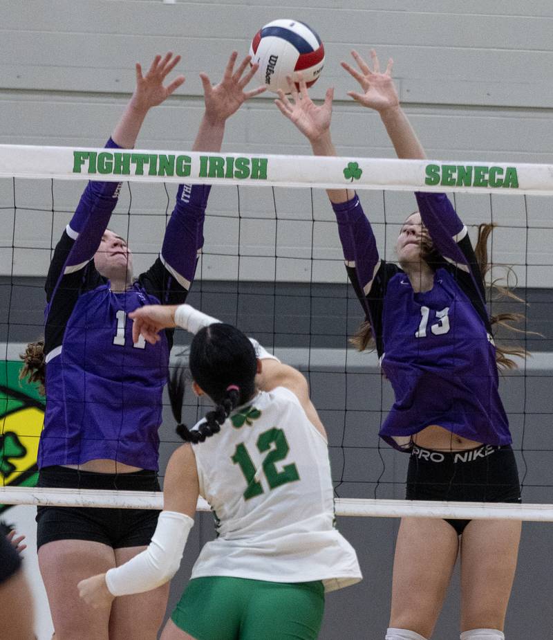 Manteno's Emily Horath and Olivia McElroy block an attack from Seneca's Lexie Buis during Class 2A regional final Thursday, Oct. 30, 2025, at Seneca High School.