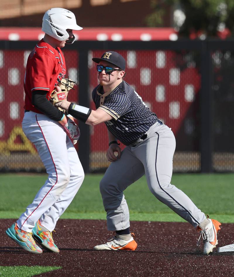 Hiawatha's Kamden Rasmus tags out South Beloit's Gage Pasiecznik as he tries to get back to second Thursday, April 16, 2026, during their game at Northern Illinois University in DeKalb.
