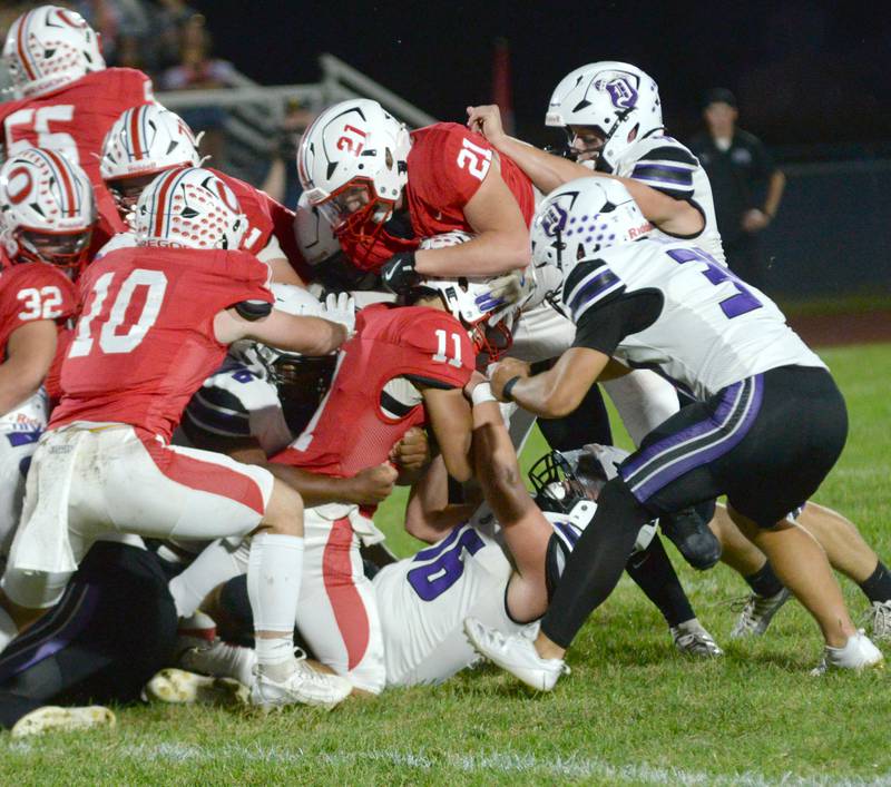 Dixon' defenders wrap up Oregon's Jayden Berry (11) on Friday, Sept. 26, 2025 at Landers-Loomis Field in Oregon.