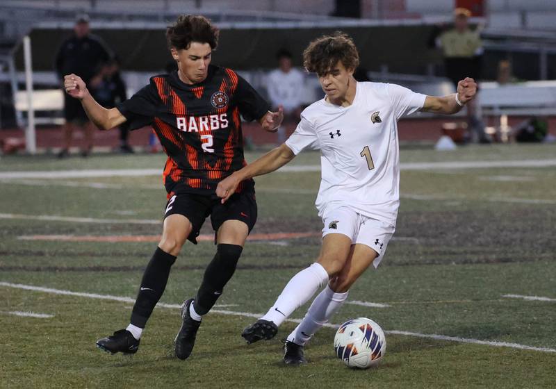 Sycamore's Noah Daykin tries to hold off DeKalb's Zach Murray during their game Thursday, Oct. 10, 2024, at DeKalb High School.