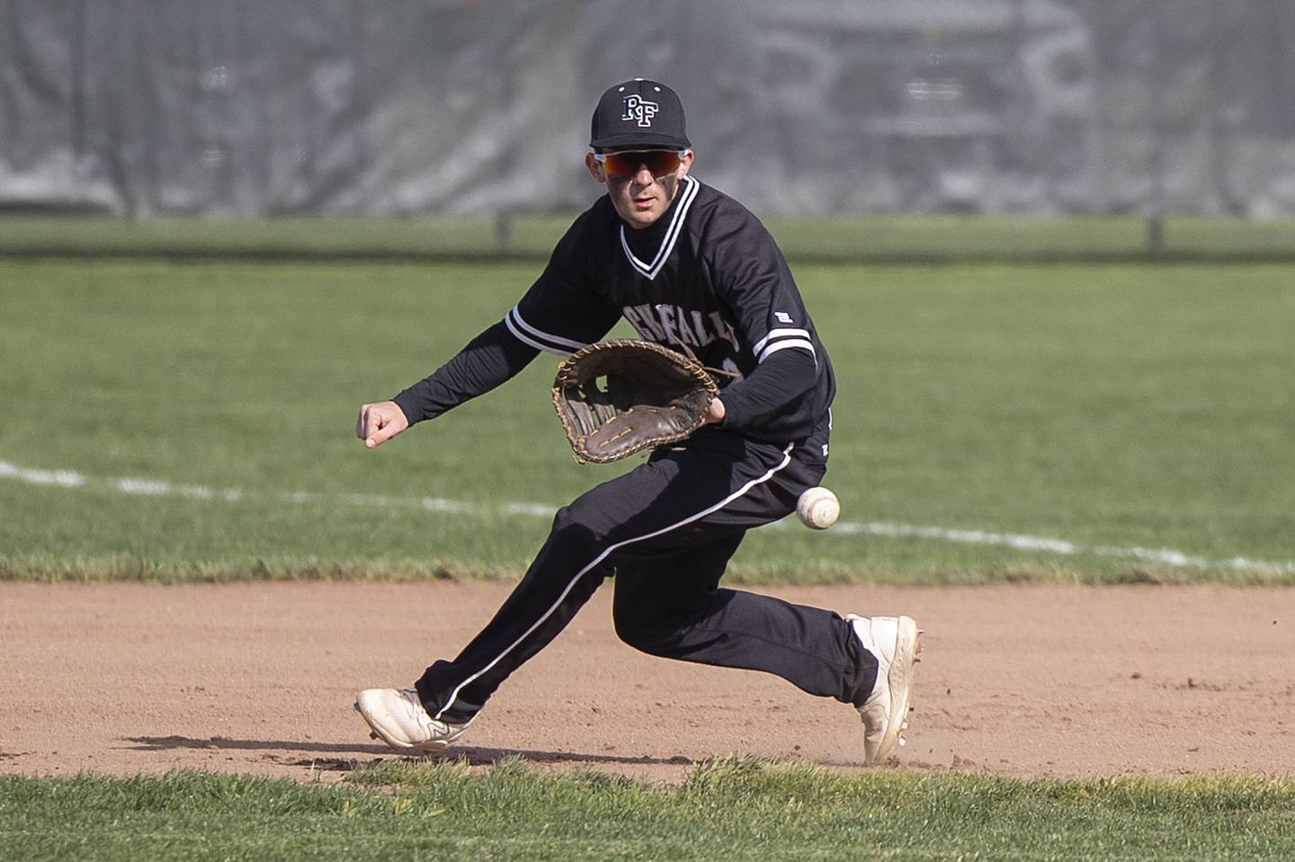 Rock Falls’ Brady Richards fields a ball at first base for an out against Dixon on Tuesday, April 18, 2023.