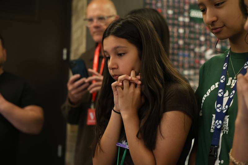 Grompers Junior High School student Evelyn Carrillo anxiously waits at a time capsule is cut open on Wednesday, May 1, 2026 in Joliet. In 1969 students placed items in a time capsule and sealed it inside a wall when an extension was built at Grompers Junior High School.