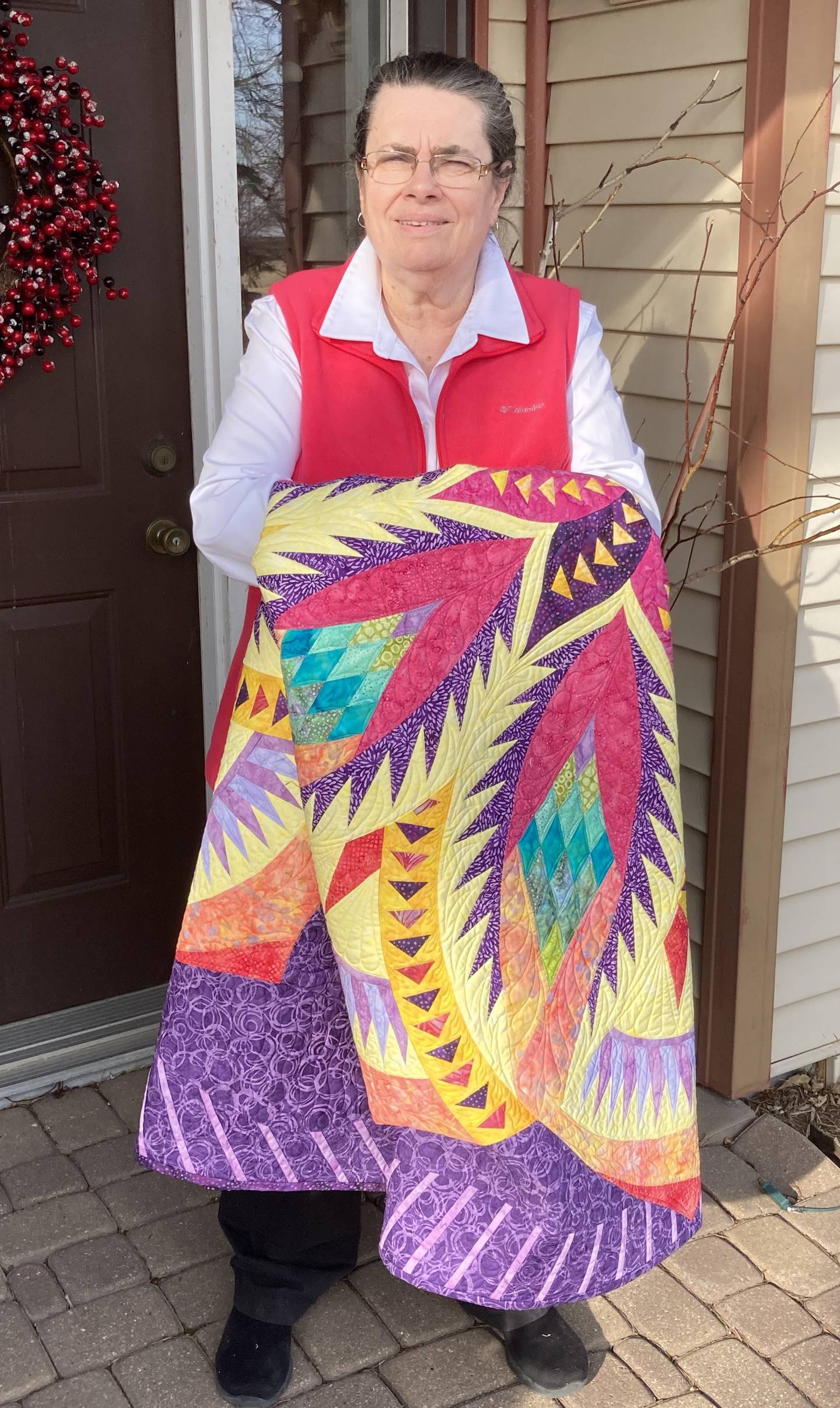 Pam Riss, of Streator, displays her quilt Vintage Rose, which will be one of 13 Peoria-area quilts on display at the Riverfront Museum in Peoria, along with Ken Burns' private collection.