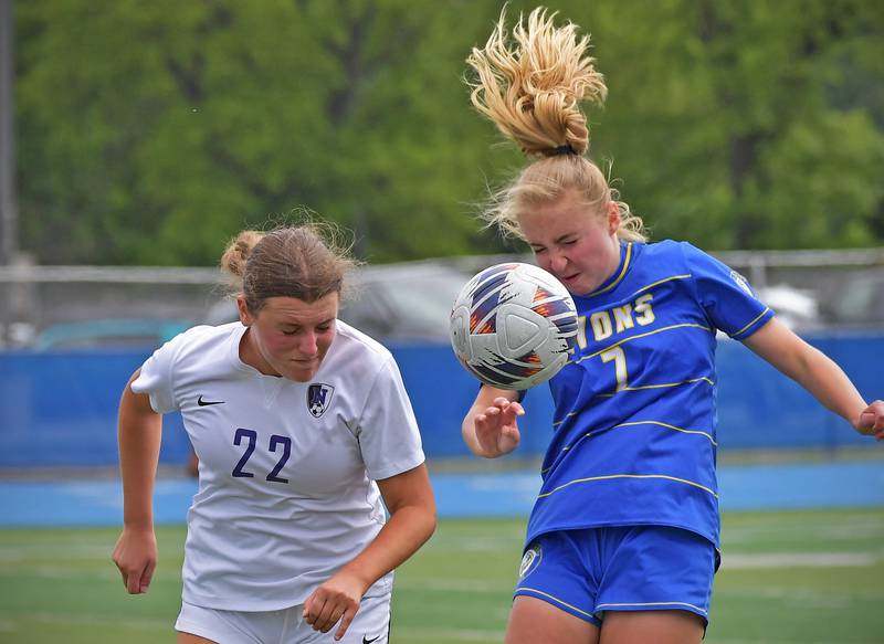 Downers Grove North’s Olivia Watland (22) and Lyons Township’s Elise Novey try to get a head on a flying ball during their Class 3A Lyons Regional final on May 23, 2026 at Lyons Township High School in LaGrange.