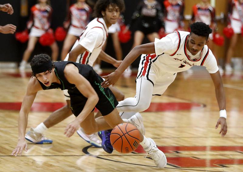 Crystal Lake South's AJ Demirov falls to the ground after being fouled by Huntley's Bryce Walker as they battled for a loose ball during a Fox Valley Conference boys basketball game Tuesday, Feb.6, 2024, at Huntley High School.