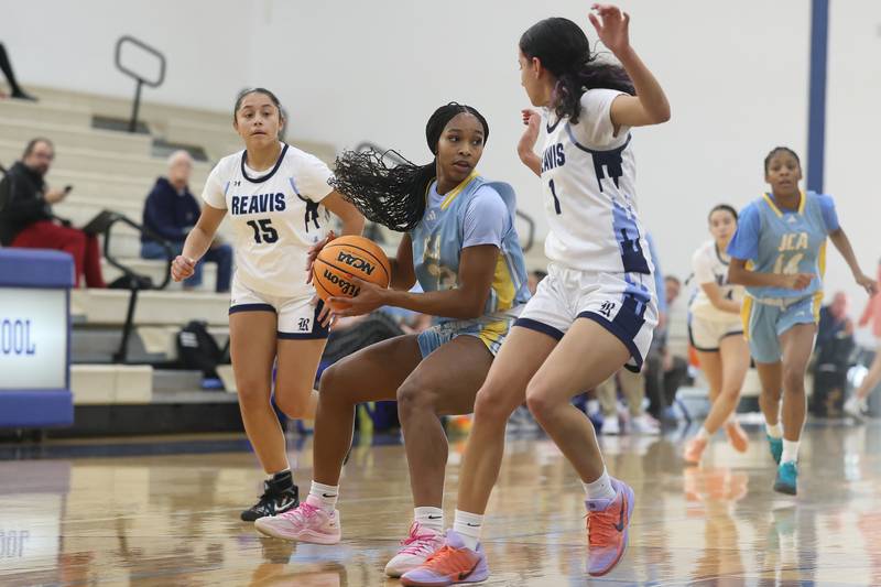 Joliet Catholic’s Symone Holman looks for a play against Reavis in the Peotone Blue Devils Holiday Classic championship game on Monday, Dec. 29, 2025 in Peotone.