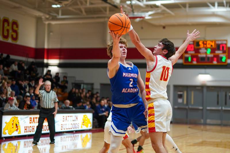 Batavia’s Joe Reid (10) defends the baseline against Marmion's Caden Anderson (2) during a basketball game at Batavia High School on Wednesday, Nov. 27, 2024.