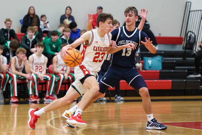 Nick Olivero of L-P dribbles in the lane whilst being guarded by Layten Gerdes of Fieldcrest on Saturday, December 14, 2024 at Hall High School in Spring Valley.