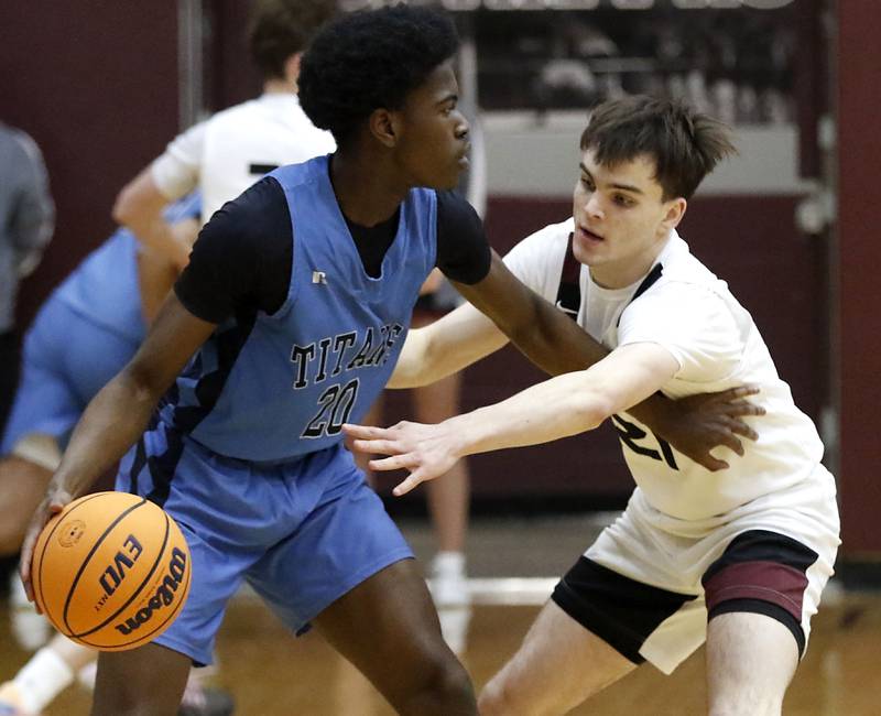 Prairie Ridge's Brendan Beu (right) tries to steal the ball from Illinois Math & Science Academy's Mofe Suleiman during a IHSA Class 3A Burlington Central Regional quarterfinal boys basketball game on Monday, feb23, 20256, at Prairie Ridge High School in Crystal Lake.