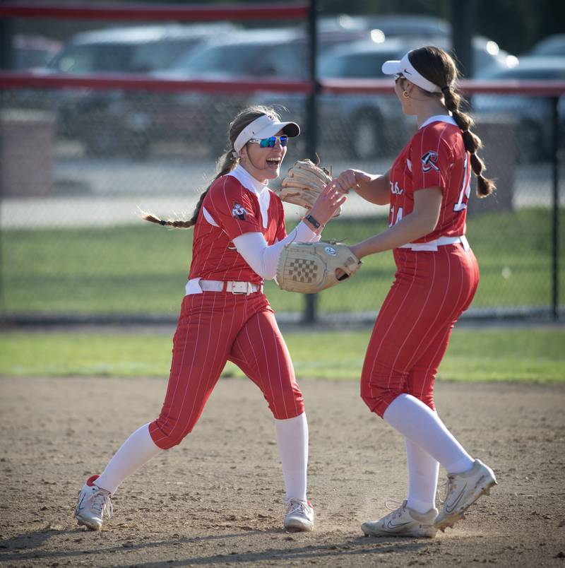 Bradley-Bourbonnais' Shannon Lee, left, and Liv Woolman, right, celebrate turning a double play in the fourth inning of Thursday's game against Lockport.