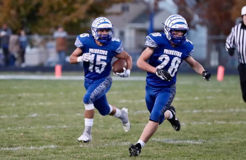 Princeton's Augie Christiansen gets an escort by teammate Preston Arkels in Friday's 3A Playoff opener against Peotone at Bryant Field. The Tigers won 56-28.