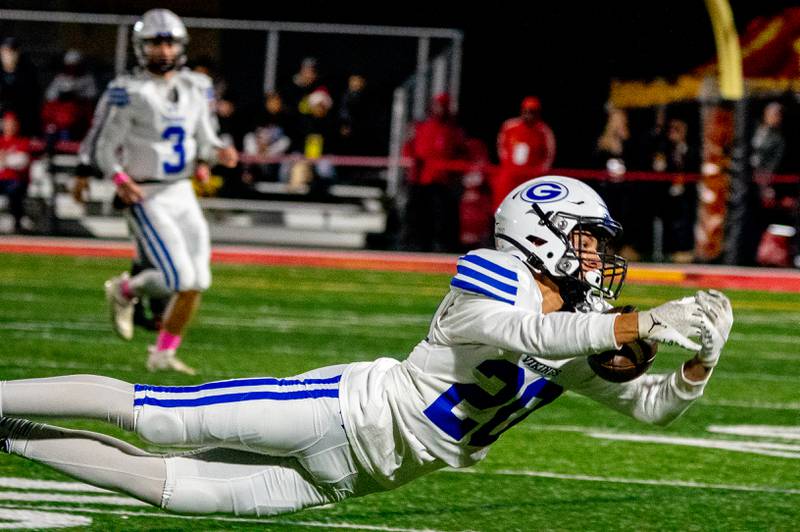 Geneva’s Anthony Pantano (20) makes a diving catch against Batavia during a football game at Batavia High School on Friday, Oct 7, 2022.