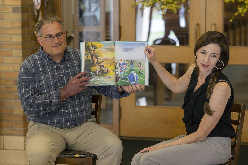 Author and St. Anne’s alumni Amanda Donahue with husband Tyler presents her book “Tyler’s Purple Arm” Friday, April 14, 2023 to third, fourth and fifth graders at the Dixon School. The book is based on Tyler’s birthmark and the struggles and accomplishments he faced growing up with the condition.