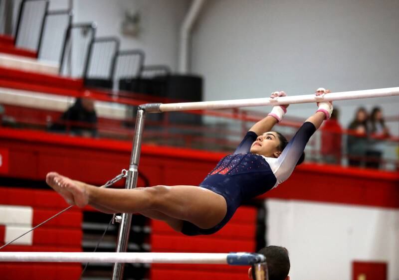Oswego Co-op’s Veda Haake competes on the uneven bars during the Hinsdale Central Sectional on Monday, Feb. 10, 2025 in Hinsdale.