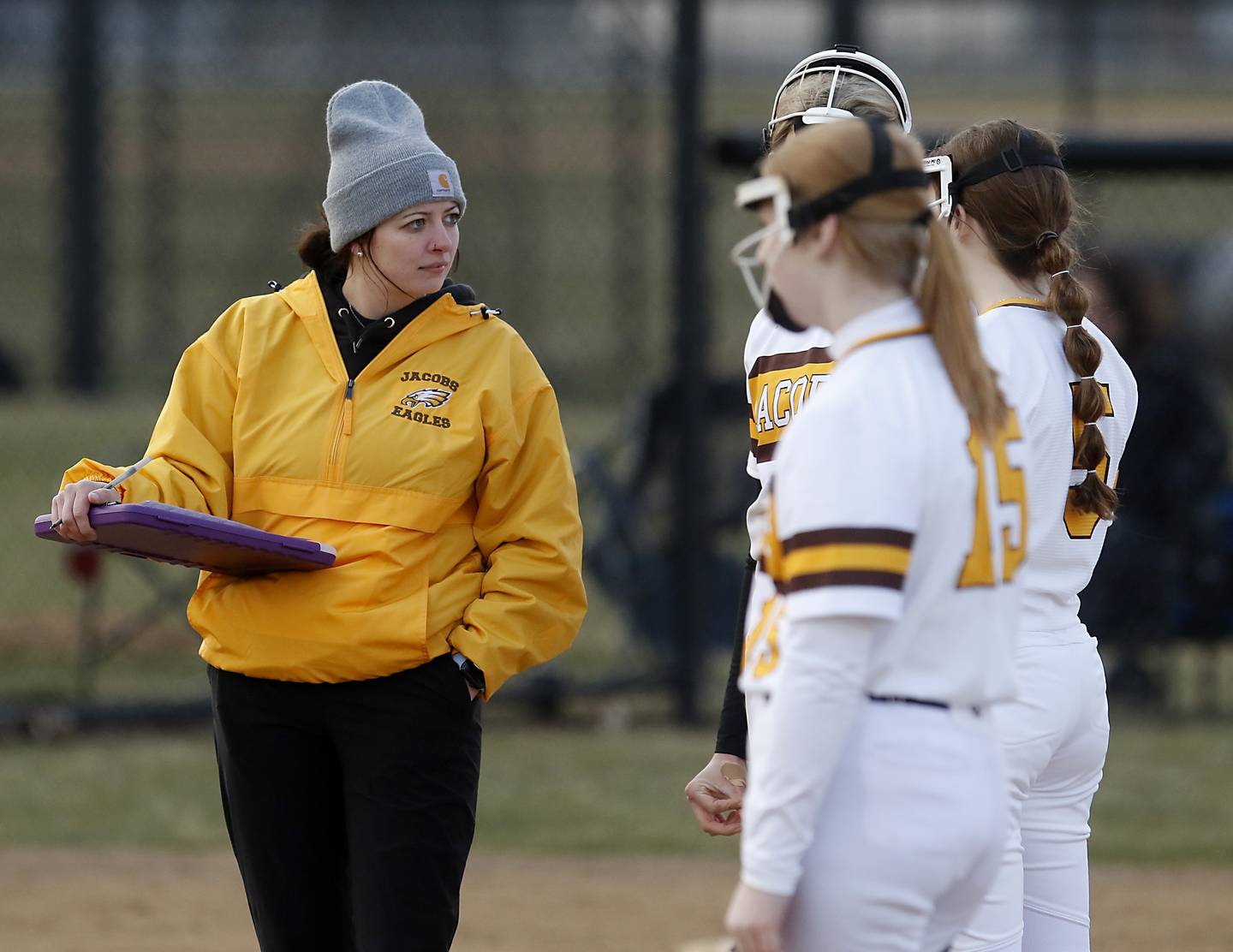 Jacobs coach Jessica Turner talks to her players during a non-conference softball game against Palatine Monday, March 20, 2023, at Palatine High School.