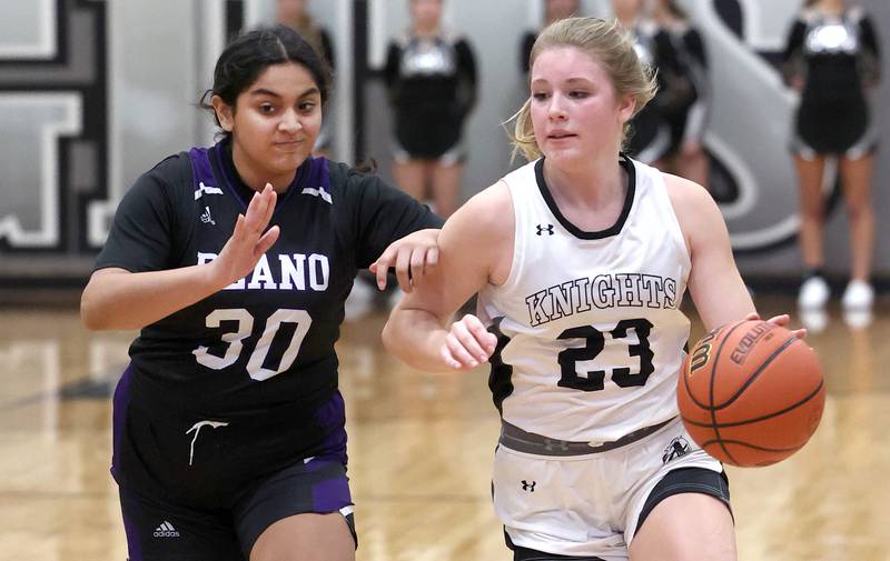 Kaneland’s Kendra Brown drives by Plano’s Aleksa Martinez during their game Tuesday, Dec. 13, 2022, at Kaneland High School in Maple Park.