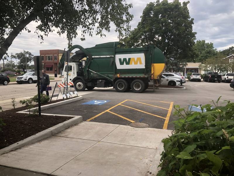 A garbage truck leaves the McHenry County College University Center parking lot in Woodstock Aug. 1, 2024.