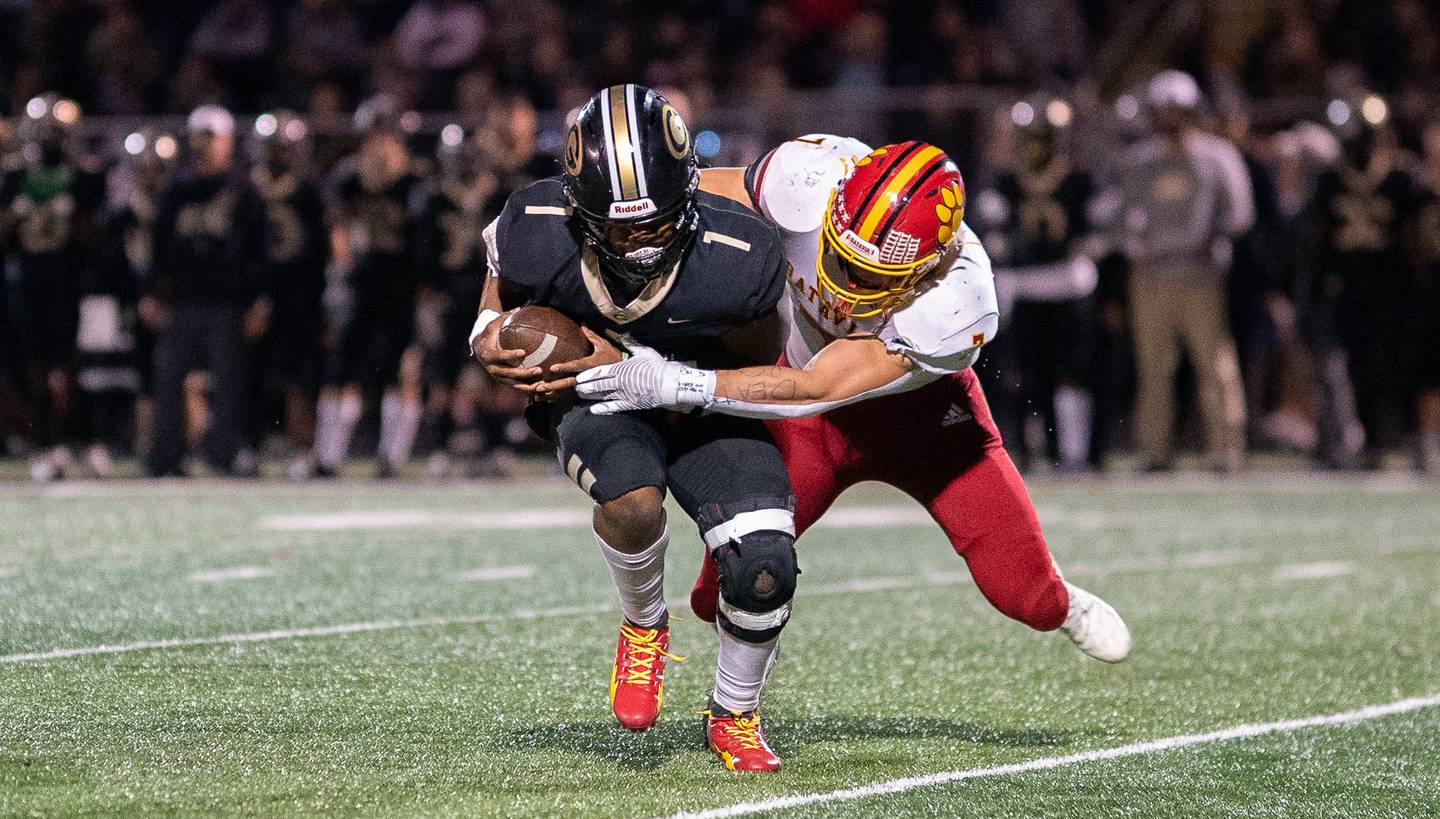 Batavia's Tyler Jansey (7) hits Glenbard North's Bland Justin (1) in the backfield for a loss during a football game at Glenbard North High School in Carol Stream on Friday, Sep 23, 2022.