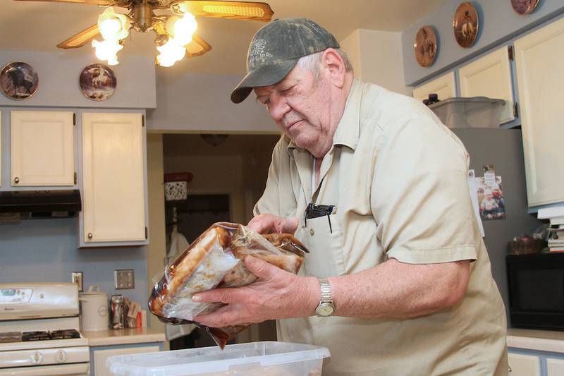 Hank Englehaupt cures bacon in his kitchen.