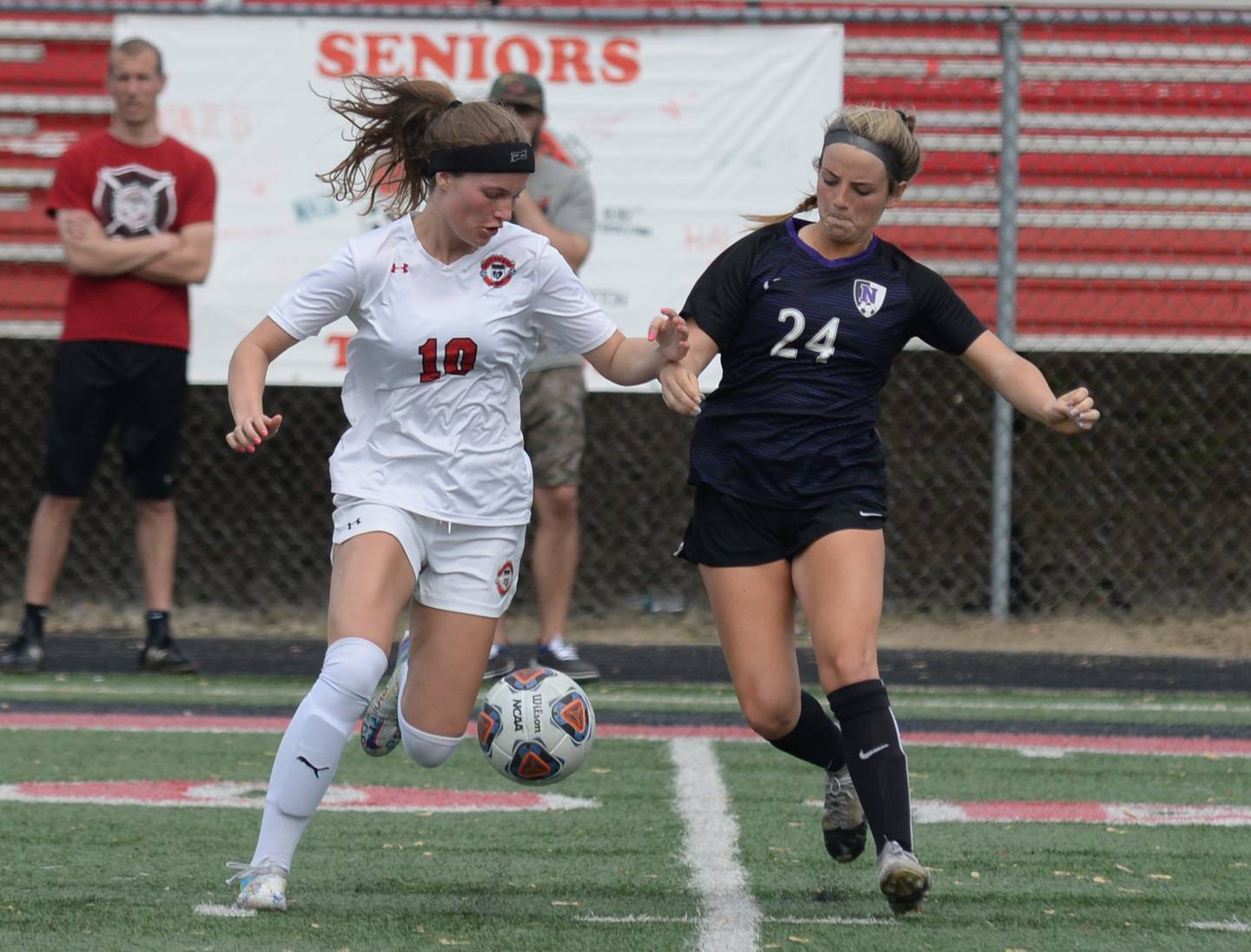 Glenbard East's Sarah Conroy defends the ball against Downers Grove North's Ann Stephens during the regional final game held Friday May 20, 2022.